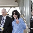 Michael arrives at Heathrow Airport in London.